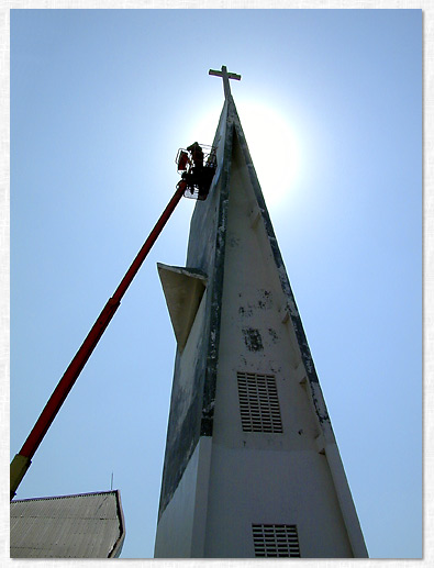 Painting the Dili Cathedral steeple in East Timor.