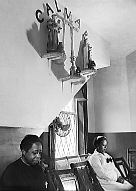 Two members of the St. Martin's Spiritual Church listen and pray.