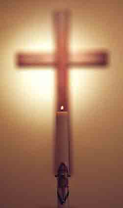 Single candle and Cross - photo by Barrett Stinson.