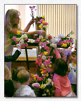 Presenting flowers to The Cross.