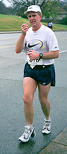 Fred Kondritz running with cross