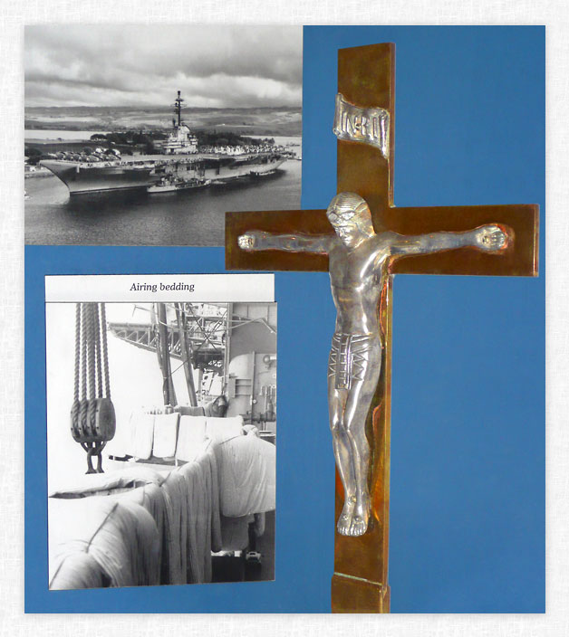 Crucifix and photos in display case.